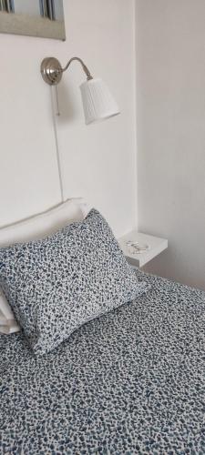 a bedroom with a bed with a lamp and a pillow at Casa da Tia in Ferrel