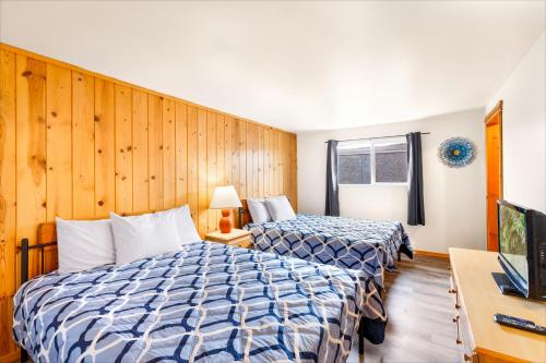 a hotel room with two beds and a television at High Dunes Condos in Ocean Shores