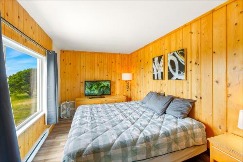 a bedroom with a bed and a large window at High Dunes Condos in Ocean Shores