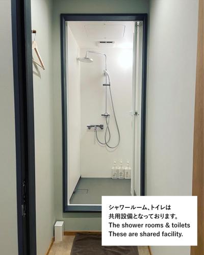 a bathroom with a shower with a mirror at 紅花舎 koukasha in Yamaguchi