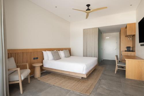 a bedroom with a bed and a table and a chair at Samphire Rottnest in Rottnest Island