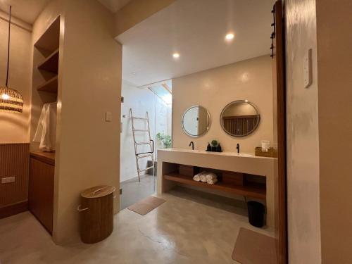 a bathroom with a sink and a mirror at Lio Villas Resort in El Nido