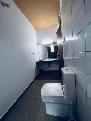 a small bathroom with a toilet and a sink at The Hostel in Mirissa