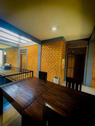 a dining room with a wooden table and chairs at The Lotus Villa Sigiriya in Sigiriya