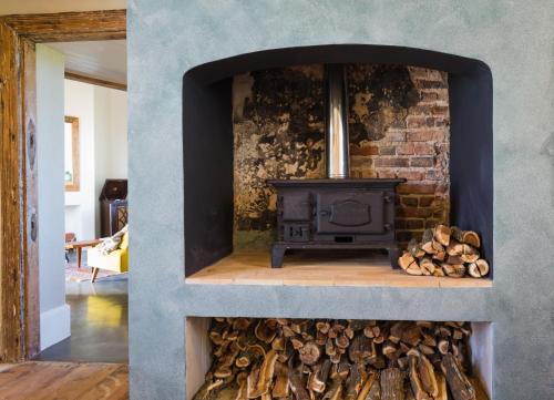 a stone fireplace with a stove in a room at Seal Point Lighthouse in Cape St Francis