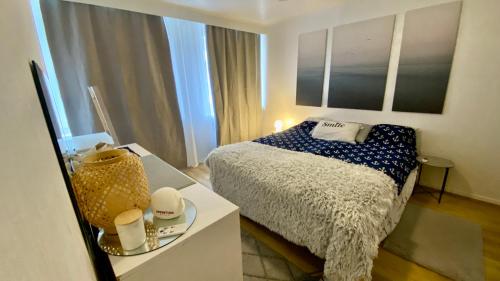 a small bedroom with a bed and a table at City Pearl II in Jyväskylä