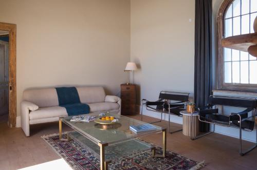 a living room with a couch and a table at Seal Point Lighthouse in Cape St Francis