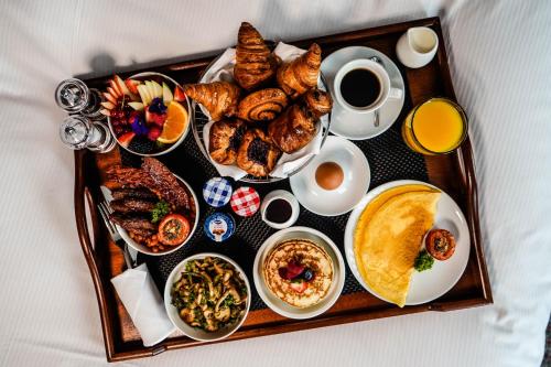 a tray of breakfast foods and coffee on a table at Hilton The Hague in The Hague