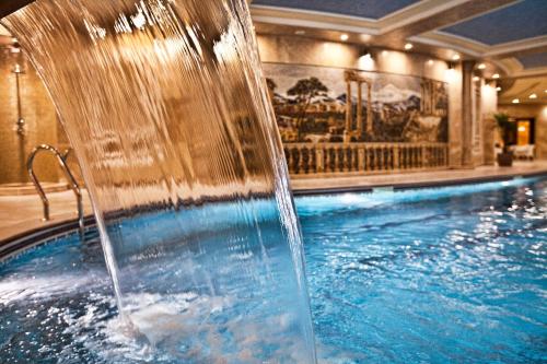 a water fountain in a swimming pool in a hotel at Multi Grand Pharaon Hotel in Yerevan