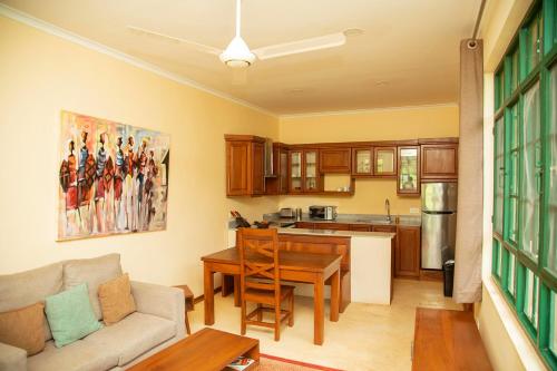 a kitchen and living room with a couch and a table at Green Side in Karangai