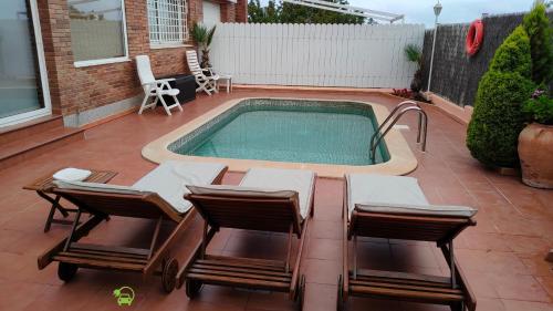 a small swimming pool with chairs and a table at Mas Japimon in Creixell