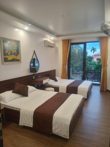 Postel nebo postele na pokoji v ubytování Quang Minh Hotel