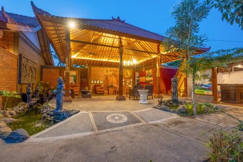 a house with a fountain in a courtyard at Taman Bidadari Eco Wellness in Pemuteran