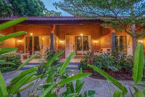 a brick house with a courtyard in front of it at Taman Bidadari Eco Wellness in Pemuteran