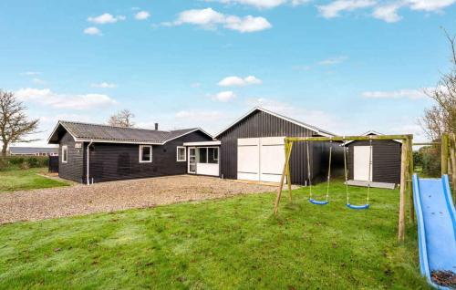 a house with a yard with a playground at Lovely Summer House By Venø Bay in Vinderup