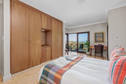 a bedroom with a large bed with wooden cabinets at San Lameer Villa 14205 - 4 Bedroom Luxury - 8 pax -San Lameer Rental Agency in Southbroom