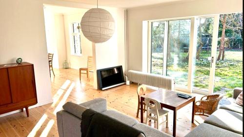 a living room with a couch and a table at Villa Apartment near Lousiana in Humlebæk