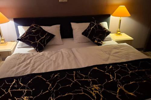 a large bed with two lamps on two tables at Apartment in Tulln an der Donau in Tulln