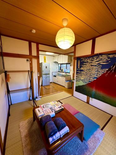 a living room with a table and a kitchen at 4 minute walk from the station,USJ33min KIX48min Namba10min, Convenience store, coin laundry, public bath, all 1 minute walk Kitakagaya INN OSAKA , 6 ppl, Near Namba to 10min,駅近徒歩4分一軒家貸切北加賀屋駅からなんば駅まで10分 in Osaka