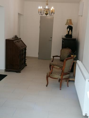 a living room with a chair and a suitcase at Landhaus Thätner Fewo 2 in Löbnitz