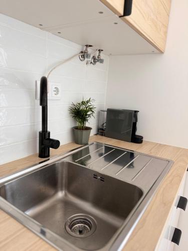 a kitchen with a stainless steel sink in a kitchen at Salty Apartments in Nazaré