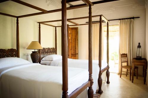 Postel nebo postele na pokoji v ubytování Qambani Luxury Resort