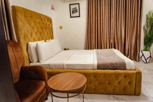 a hotel room with a bed and a chair at 247 Luxury Hotel in Lekki