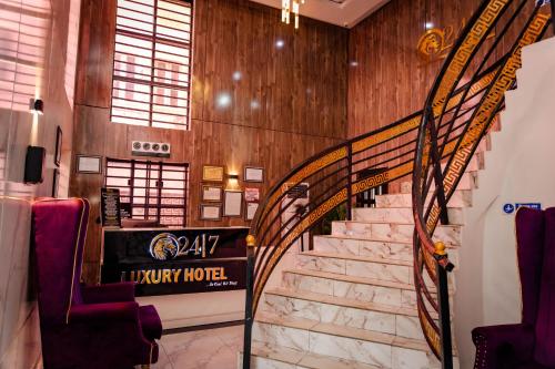 a spiral staircase in a room with wooden walls at 247 Luxury Hotel in Lekki