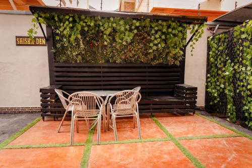 a patio with two chairs and a bench with a plant at 247 Luxury Hotel in Lekki