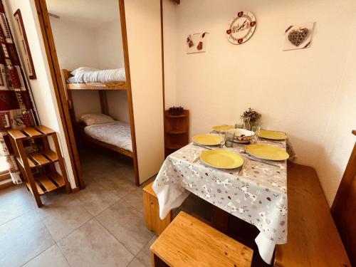 une chambre avec une table recouverte de plaques jaunes dans l'établissement Studio cosy 4 pers avec balcon, proche pistes et centre. Animaux admis. - FR-1-757-129, à Landry