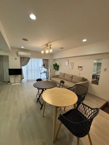 a living room with two tables and a couch at PALAIS GRACE 301 in Tokyo