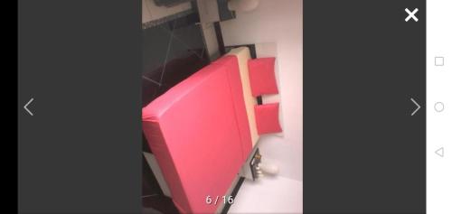 two pictures of a pink computer monitor on a wall at Orchidée in Saint-André