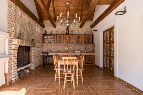 a dining room with a table and a fireplace at Fehér Galamb Vendégház in Tolmacs