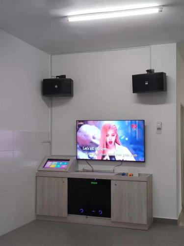 a flat screen tv on a wall in a room at Nieo Village 1 in Port Dickson