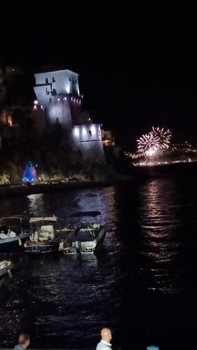 a large ship with fireworks in the water at night at Victor's Room in Cetara