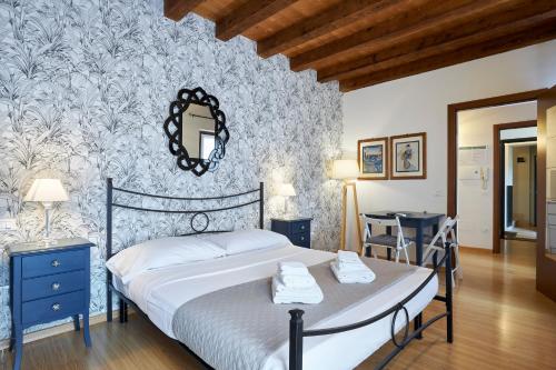 a bedroom with a bed with a blue and white wallpaper at Residence "Professor's nest" - Verona Apartments in Verona
