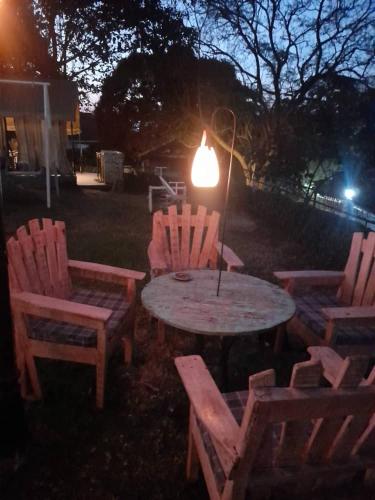 a table and chairs with a lamp and a table and chairs sidx sidx sidx sidx at Boulevard Inn Mt Meru in Arusha