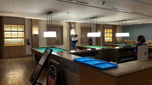 a room with ping pong tables in a restaurant at Tu Casa at Pico de Loro - Myna B in Nasugbu