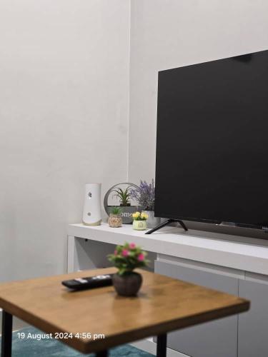 a flat screen tv sitting on top of a table at The Shore Home Suites Kota Kinabalu City Sabah Center in Kota Kinabalu
