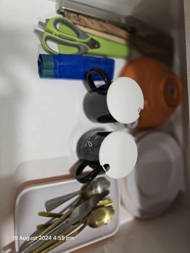 a drawer with scissors and other kitchen utensils at The Shore Home Suites Kota Kinabalu City Sabah Center in Kota Kinabalu