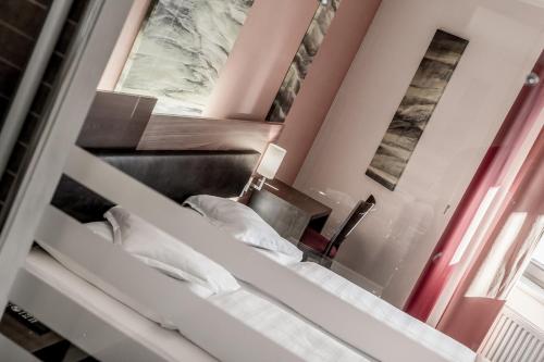 a room with a bunk bed and a mirror at Josl Mountain Lounging Hotel - Adults only! in Obergurgl