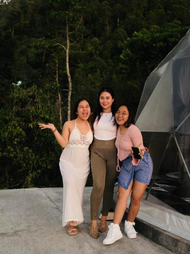 a group of three women standing next to each other at Kubah Bali Glamping in Kintamani