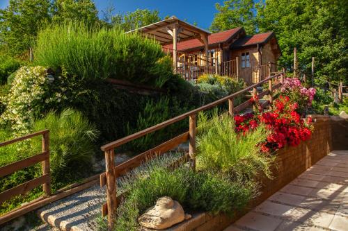 a garden with flowers and a house in the background at Pian Del Mund in Borgomale