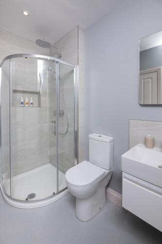 a bathroom with a shower and a toilet and a sink at Caboose in Salisbury