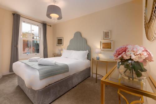 a bedroom with a bed and two tables with flowers at Caboose in Salisbury