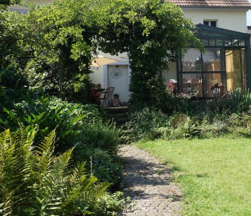 a garden with a path leading to a house at Ferienhaus Glücksnest in Hetzerath