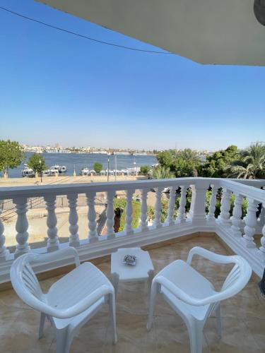 a balcony with two chairs and a view of the beach at El Mesala Hotel in Luxor