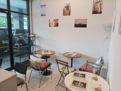 a room with two tables and chairs and a window at Merlin MANSION 107 in Ban Khlong Samrong