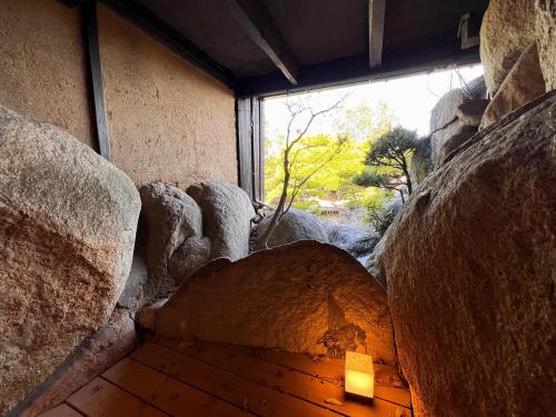 a room with a window and some rocks at UMI-IRO Onomichi Senkoji Park in Onomichi