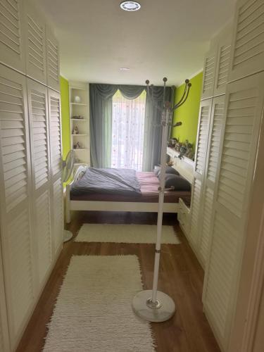 a small room with a bed and a window at Apartma Mladinska in Maribor